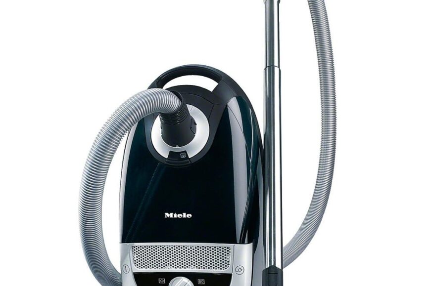 Afbeelding van een zwarte stofzuiger van het merk Miele, uitgerust met een flexibele slang en een metalen buis. De stofzuiger heeft een moderne uitstraling en is voorzien van bedieningsknoppen aan de voorkant voor eenvoudige aanpassing van de zuigkracht.