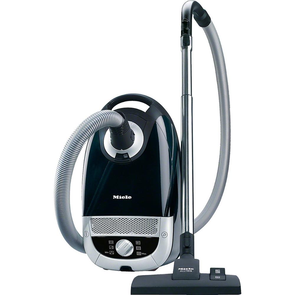 Afbeelding van een zwarte stofzuiger van het merk Miele, uitgerust met een flexibele slang en een metalen buis. De stofzuiger heeft een moderne uitstraling en is voorzien van bedieningsknoppen aan de voorkant voor eenvoudige aanpassing van de zuigkracht.