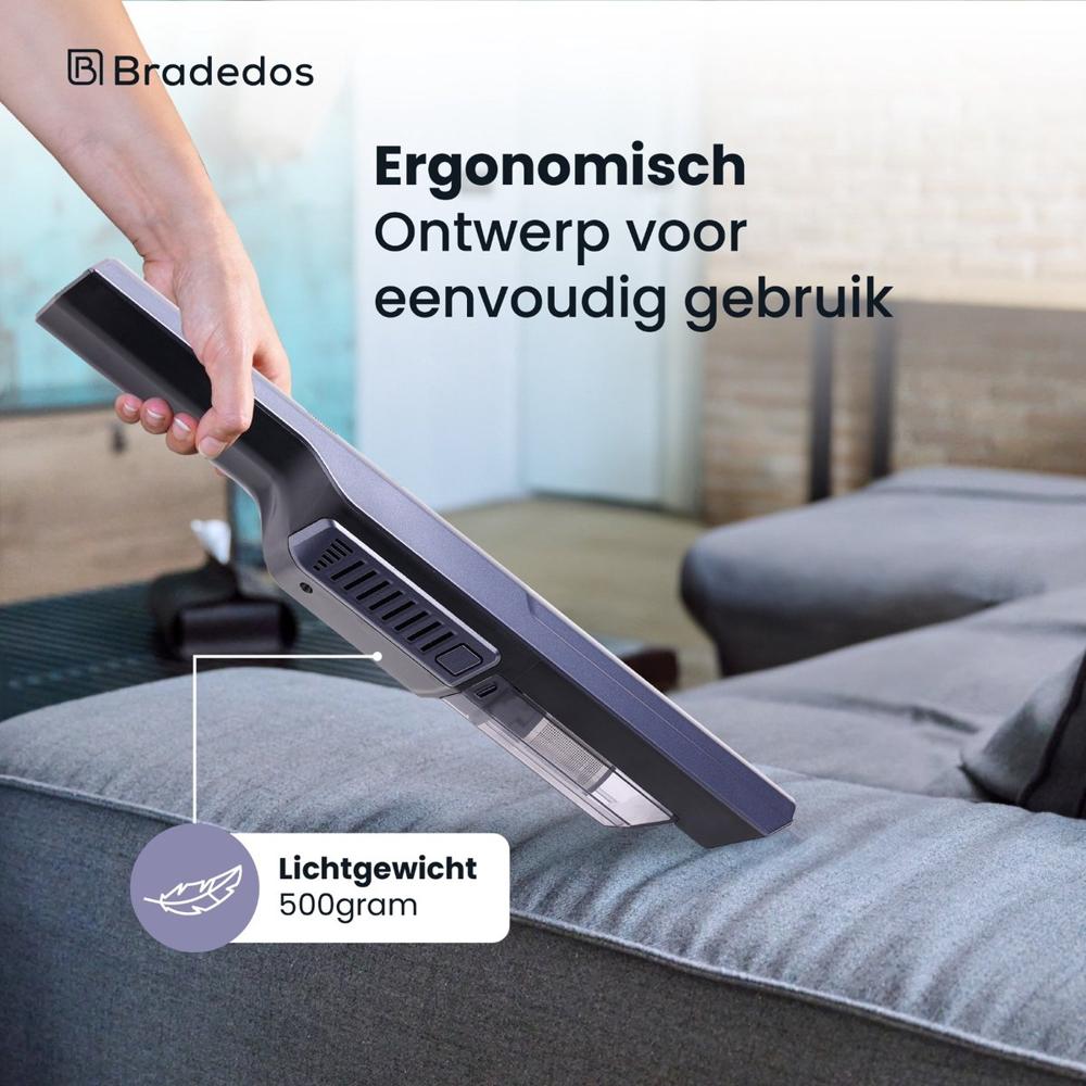 Afbeelding van een handdiepzuiger met een ergonomisch ontwerp, die gemakkelijk wordt vastgehouden terwijl deze boven een bank wordt gehouden. De diepzuiger is lichtgewicht, met een gewicht van 500 gram, wat het gebruik vereenvoudigt.